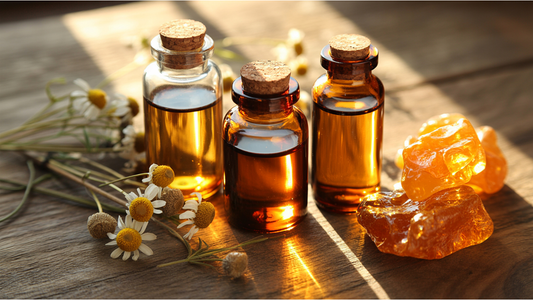 three glass bottles of botanical oils with chamomile flowers on wooden surface, natural plant-based skincare ingredients