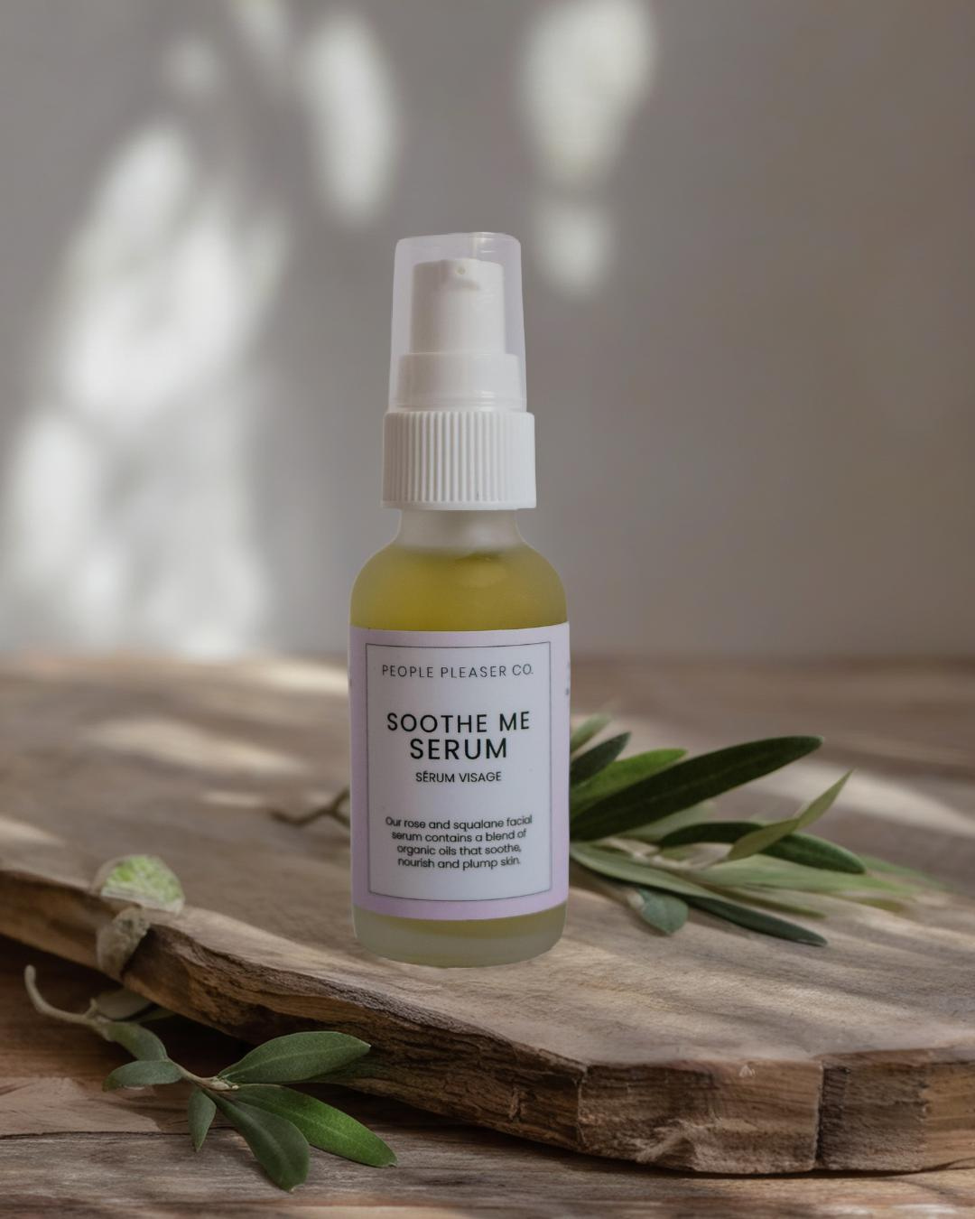 People Pleaser Co Soothe Me Serum with olive branch on wooden surface containing vegan squalane plant based facial oil serum